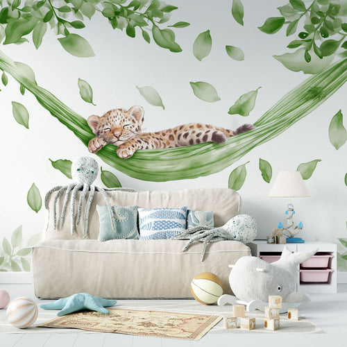 Baby leopard wallpaper with a cub asleep in a green leaf hammock