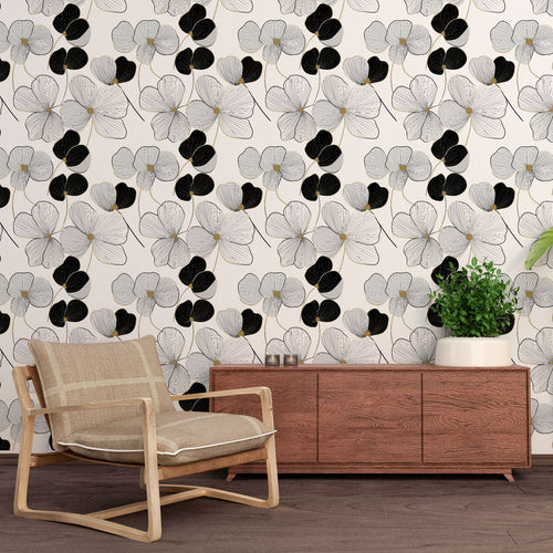 Black and white floral wallpaper with ivory blooms dark elements and delicate gold touches