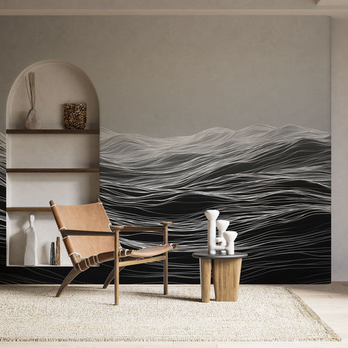 Black and white wall mural of fluid abstract wave lines on a pale ground