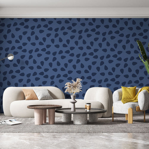 Blue and navy abstract wallpaper installed in a living room